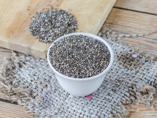 chia seeds in cup on sack, closeup chia seeds,