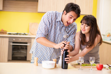 Obraz na płótnie Canvas Young couple celebrating wedding anniversary at kitchen 