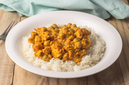 Chickpea curry with rice on wooden table