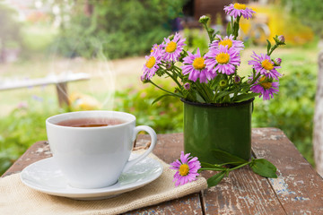 A Cup of tea on a wooden table.