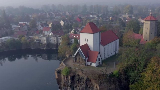 Church Overlooking a Small and Beautiful Lake on a Foggy Morning