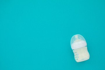 Baby bottle whith mixture milk baby feeding blue background top view