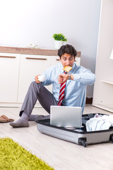 Young handsome businessman preparing for trip