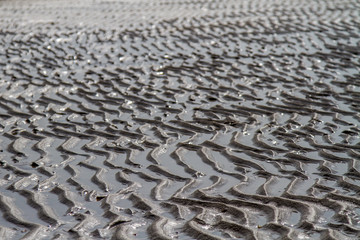Strukturen im Sand am Strand