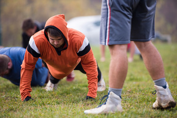 american football team doing push ups