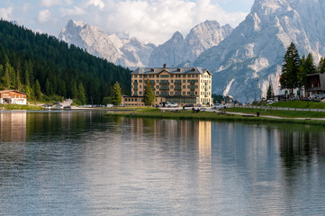 Fototapeta premium Imression of the buildings along the shoreline of Lake Misurina, in the Italian Dolomites, on a Summer's Afternoon.