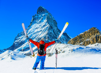 Man skiing on fresh powder snow. Ski in winter season, mountains and ski touring backcountry...