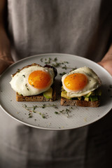 toast with avocado and egg, breakfast concept.