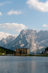 Imression of the buildings along the shoreline of Lake Misurina, in the Italian Dolomites, on a Summer's Afternoon.