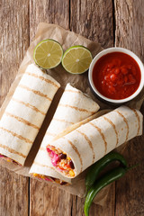 Dietary grilled vegetarian burrito with rice and vegetables close-up. Vertical top view