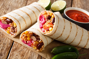 Delicious spicy vegetarian burrito with rice and vegetables close-up. horizontal