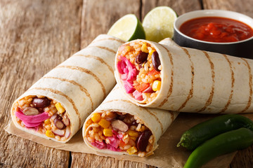 Popular appetizer vegetarian burrito with rice and vegetables close-up. horizontal