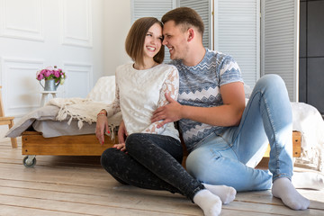 Happy couple sitting on the floor