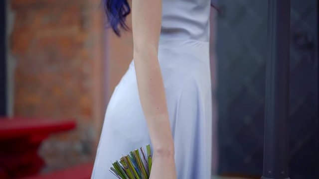Bouquet of blue flowers in the hand of a slender girl's dead bride Halloween makeup