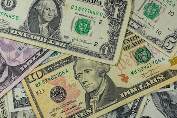 Fototapeta na wymiar Background of different american dollar banknotes