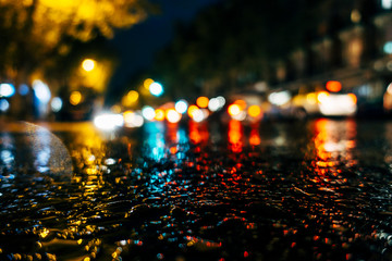 The rain falls in the night traffic of Madrid Spain.