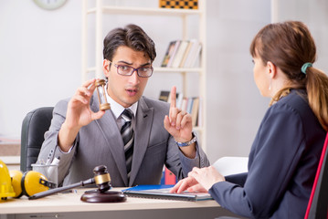 Lawyer talking to client in office