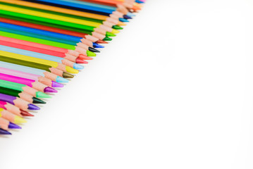 Fototapeta premium colored pencils in a row on a white background, creativity
