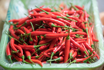 red chili pepper in a basket in a market