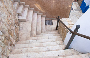 Old stone stairs in town in Europe. Abstract background outdoor.