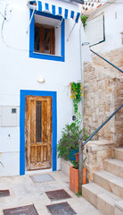 White mediterranean house with blue greek window and door in Europe.
