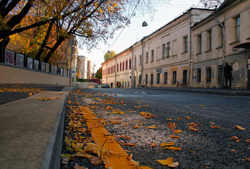 Yellow line of road marking 'No waiting', 'No standing'  on the Khokhlovsky Lane, old buildings in...
