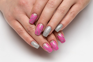 Pink moon manicure with silver glitter with silver waves, stripes on long square nails close-up


