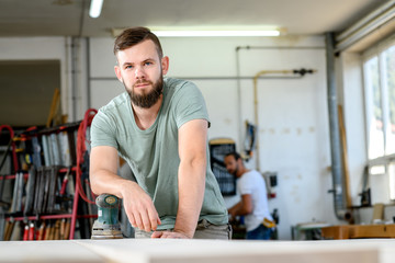 young worker in a carpenter's workshop