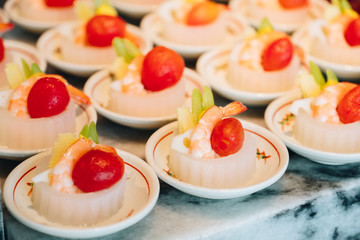 Extreme close up of shrimp and crab cocktail salad served in transparent glasses.