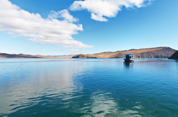Lake Baikal on a sunny autumn day. Freight regular passenger ferry transports tourists from Olkhon Island through the Olkhon Gate
