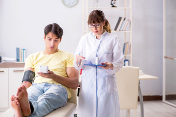 Obraz premium Young doctor checking patients blood pressure