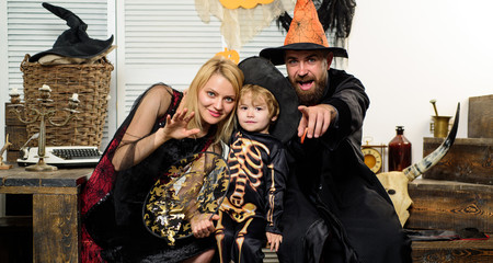 Family photo on Halloween. Autumn festival in October. Mom, dad and son getting ready for a...