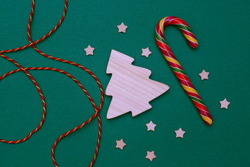 new year's layout of a wooden Christmas tree, stars, colorful candy and beautiful lacing