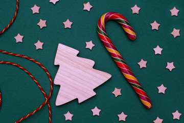 new year's layout of a wooden Christmas tree, stars, colorful candy and beautiful lacing