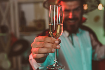 White wine in a glass. Halloween party. Fun man. Alcohol. Bearded male enjoying party. October mood. Sexy handsome guy.