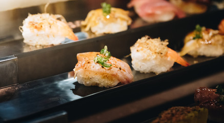 japanese sushi buffet on the counter bar in restaurant