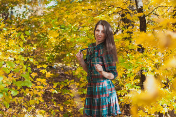 Portrait of Young Fashion Woman Outdoor on Autumn Background