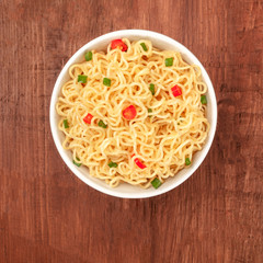 Overhead photo of noodles with chili peppers and place for text