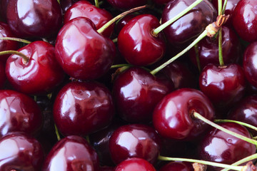 Сloseup red ripe cherries texture with light reflection