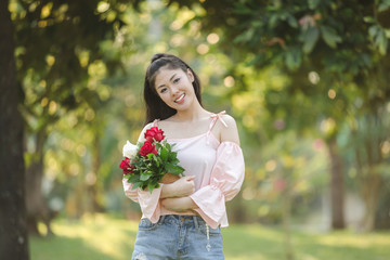 young woman asian girl with roses red smiling hoppy in valentines day