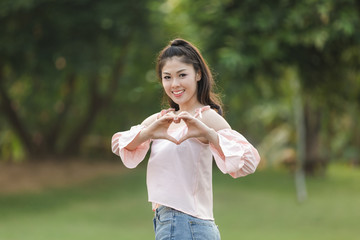 Fototapeta premium girl with a heart-shaped hand