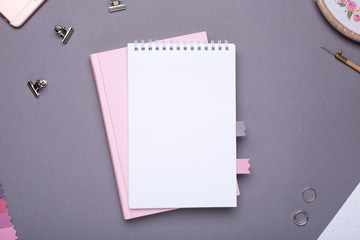 White notepad with pink book on grey background in vintage style
