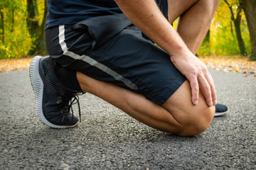 Fit male getting ready to run in the forest