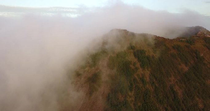 flying to the top of the Batur volcano with many tourists through clouds, Bali