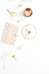 Gold styled home workspace with notebook, scissors and clips on white background. Flat lay, top view.