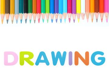 Colored pencils row with alphabet sponge rubber of text 