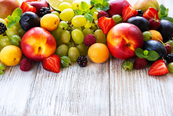Fresh summer fruits and berries on a white wooden table
