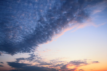 Fototapeta na wymiar Orange spindrift clouds and blue sky. Cloudscape. Beautiful sunrise