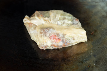 Roti fried on pan - mix egg, vegetable and chicken with roti dough sheet frying with butter in the hot pan, white sugar cane as topping, Indian pancake