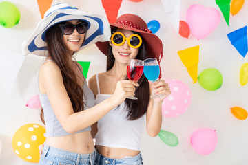 celebration new year or birthday party group of asian young woman and confetti happy,funny concept.drinking wine happy and fun in new year celebrate, color balloon  background.